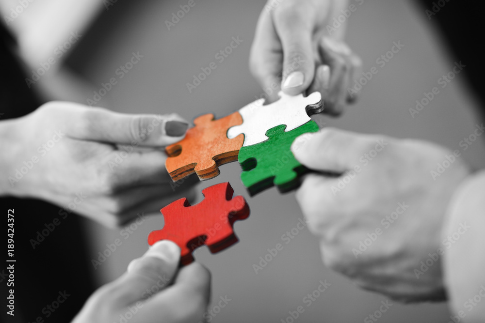 Group of business people assembling jigsaw puzzle Group of business people assembling jigsaw puzzle