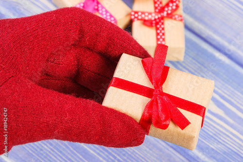 Hand of woman in gloves with gifts for Valentines Day