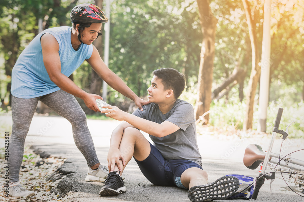 Sport men cyclist riding mountain bike spin down and fall injured. Sport life concept in the summer Sport men cyclist riding mountain bike spin down and fall injured. Sport life concept in the summer