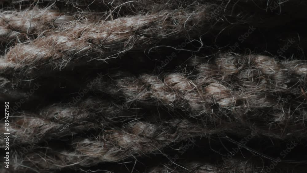 Ball of string extreme close up. String in macro with rotating camera move. Natural Brown Jute Burlap Rustic Twine String Rope Cord Decor. Lots of fibers and weaves. 4k