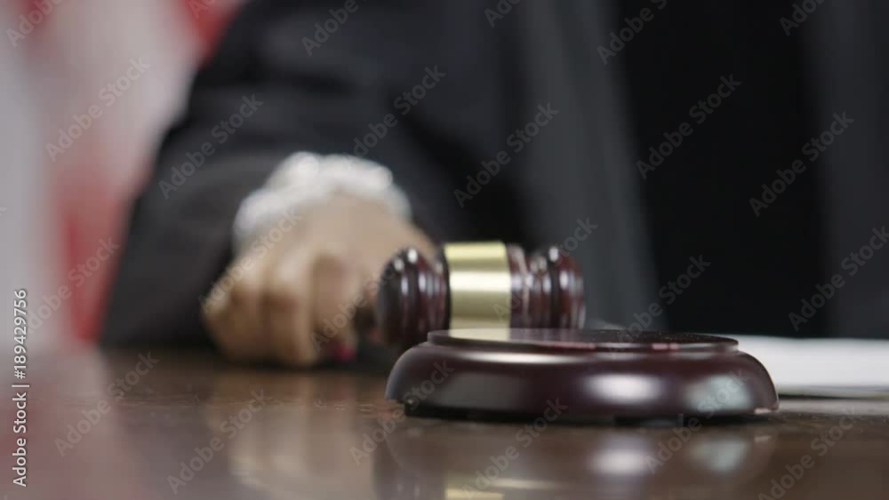Female African American judge lowering a gavel in courtroom