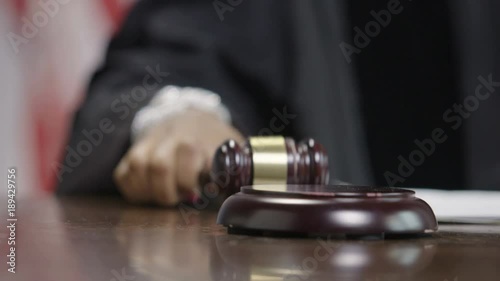 Female African American judge lowering a gavel in courtroom