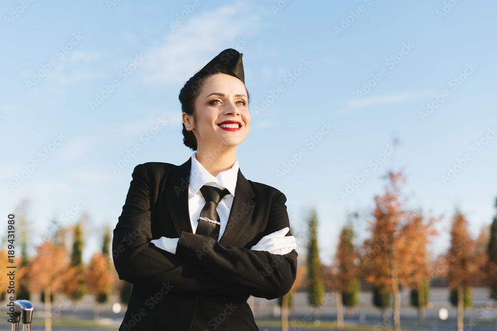 happy woman stewardess in uniform posing at camera happy woman stewardess in uniform posing at camera