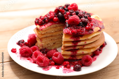 stack of pancakes and berry syrup