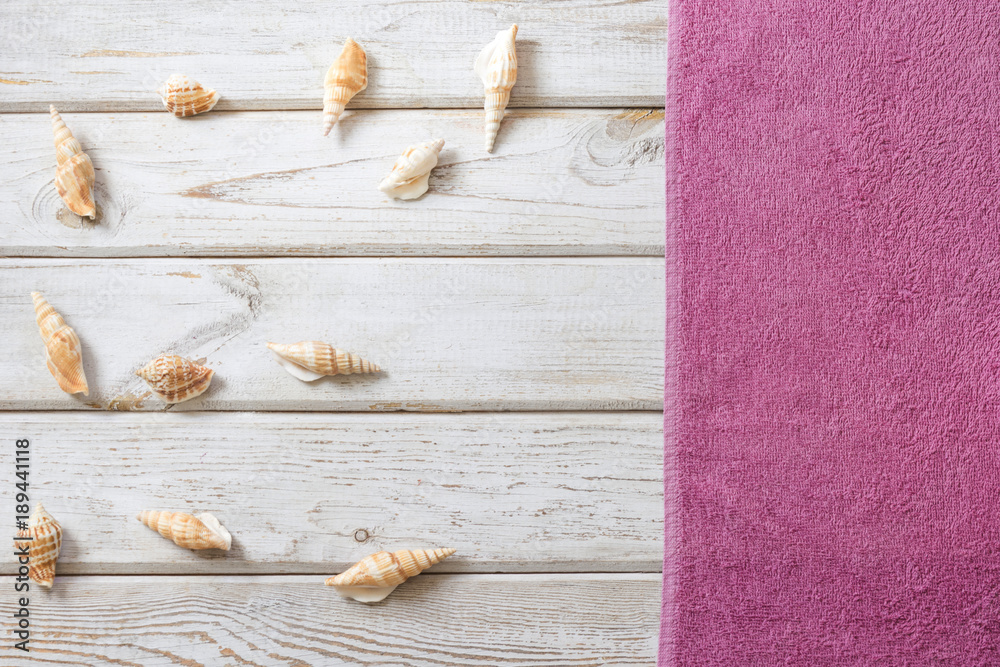 Beach towel and summer accessories on white wooden background. Travel concept. Blank mock up for advertising or packaging. Beach towel and summer accessories on white wooden background. Travel concept. Blank mock up for advertising or packaging.