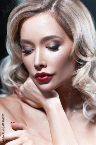 Luxurious young blond woman with red lipstick
