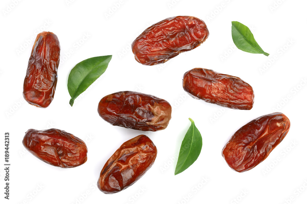 dry dates with green leaves isolated on white background. Top view. Flat lay pattern dry dates with green leaves isolated on white background. Top view. Flat lay pattern