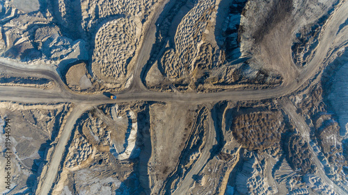 Coal section, Primorsky Krai, Russia - March 2017: chalk pit. Excavator pours soil into the truck photo