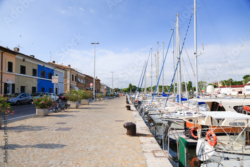 Scenic view of pier with ancient buildings, ships, yachts in Pesaro, Marche, Italy photo