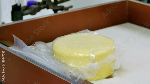 Worker in a warehouse of homemade cheese prepared and stocked cheese, 4K Video Clip