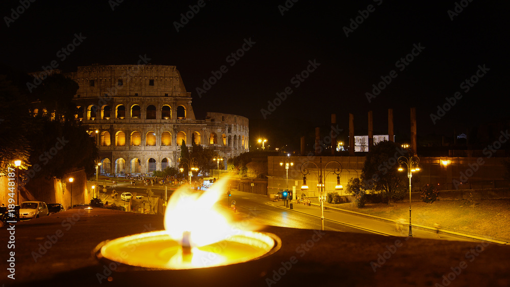 View of the Colosseum in Rome with a flame, Italy