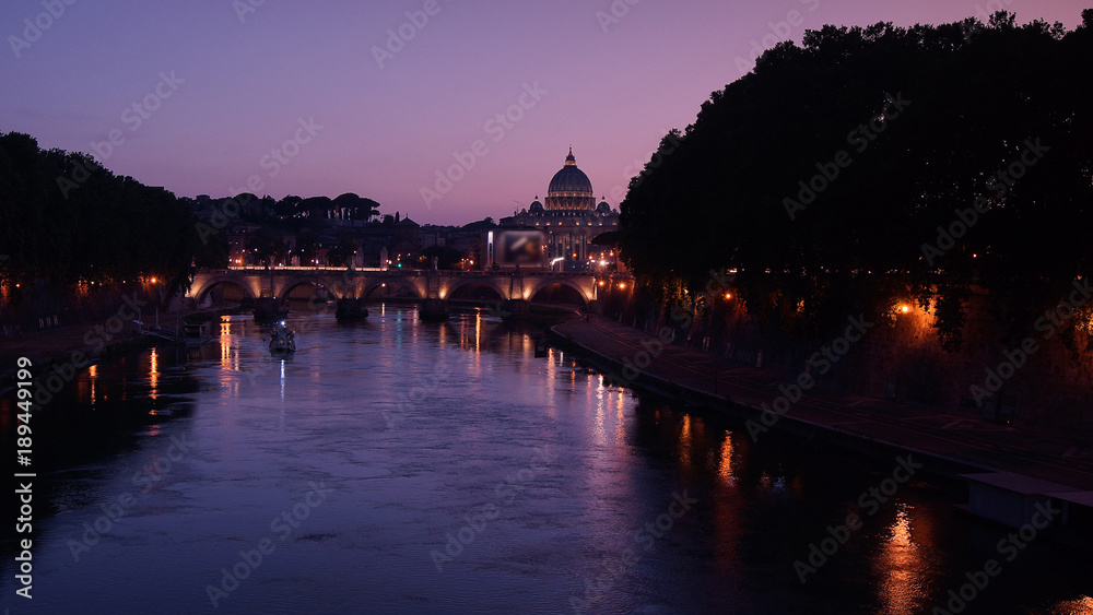 Fototapeta premium View of the St. Peter's Basilica and Ponte Sant'Angelo at sunset in Rome, Italy.