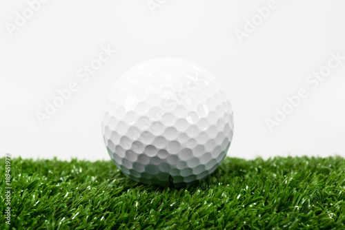 White golf ball on green lawn.