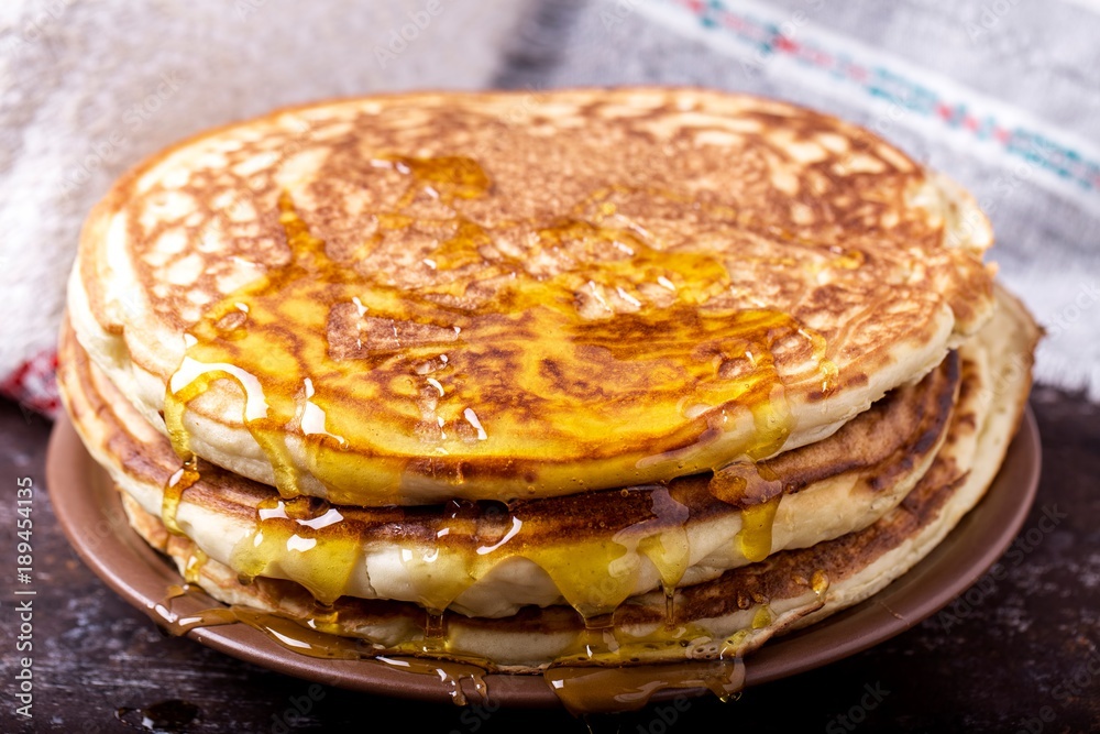 Thick pancakes with honey. Tasty and sweet pancakes Thick pancakes with honey. Tasty and sweet pancakes