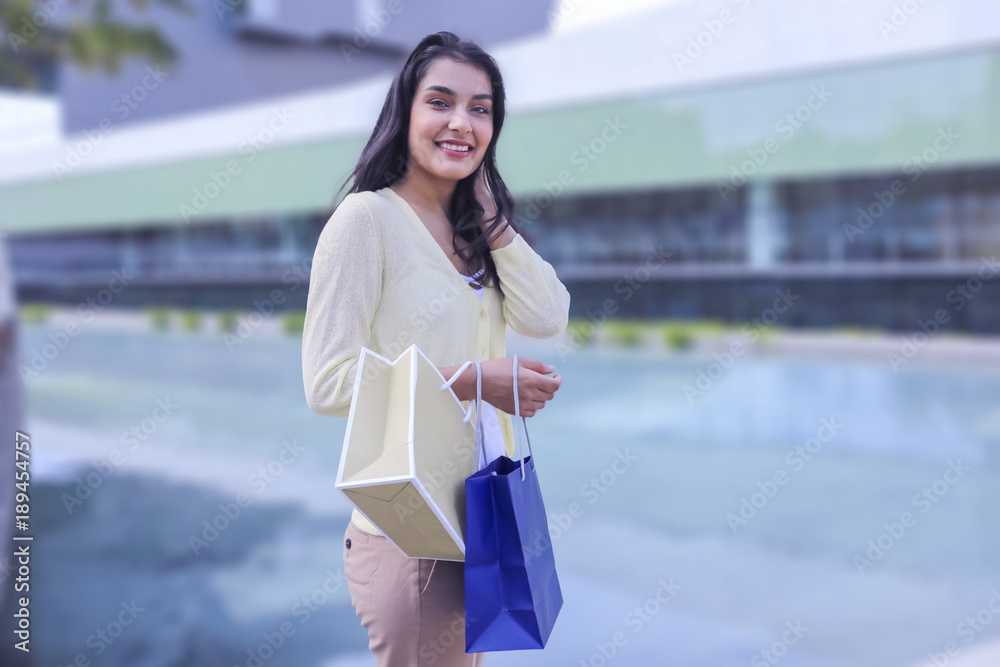 Fototapeta premium A beauty shopping woman with paper bags