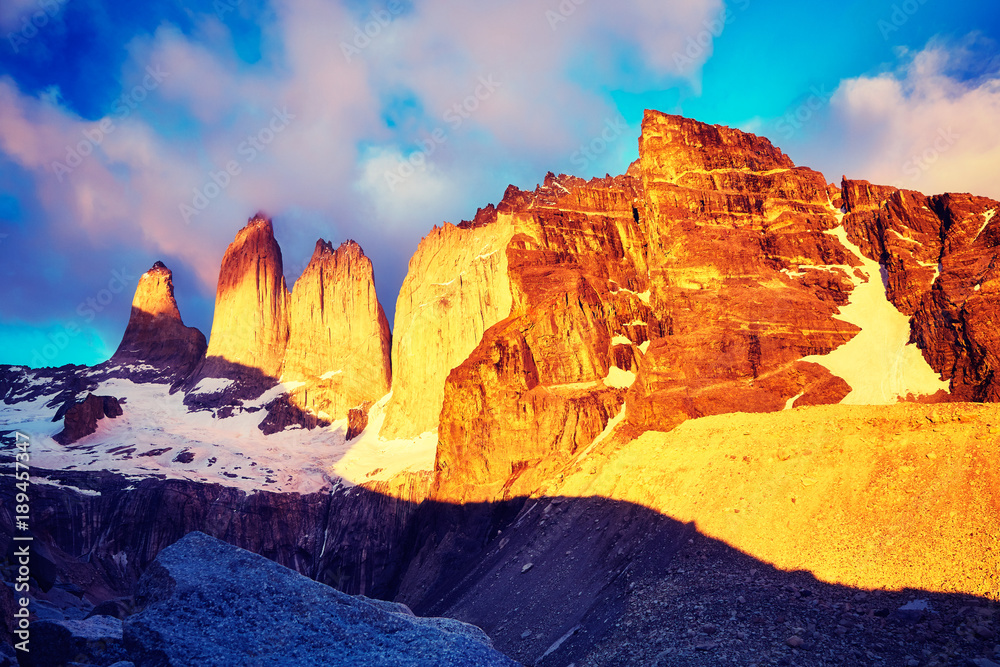 Torres del Paine famous rock formations at pink sunrise, color toned picture, Patagonia, Chile.