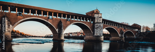 beautiful river landscape - covered bridge over Ticino river at Pavia - italian landscape panorama