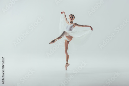 Fototapeta Naklejka Na Ścianę i Meble -  young elegant ballerina dancing in studio, isolated on white
