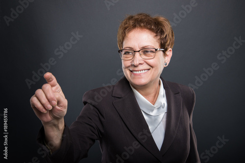Business senior lady using invisible touchscreen
