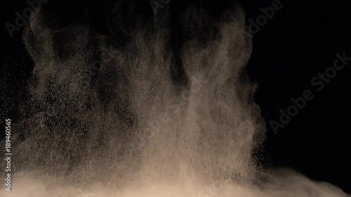 bright yellow powder explosion on black background