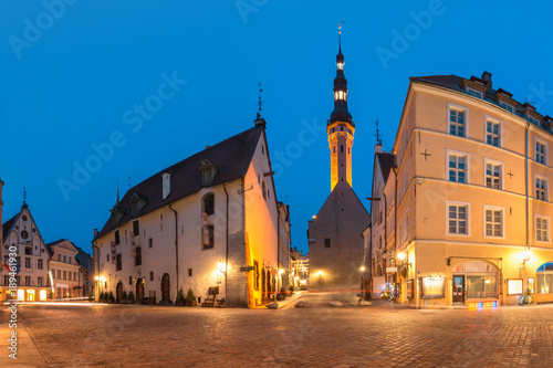 Beautiful illuminated street of Medieval Old Town and Town Hall in the morning blue hour, Tallinn, Estonia