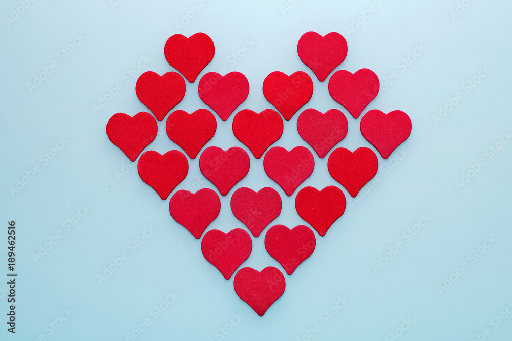 Red heart made up of small decorative hearts on a white background