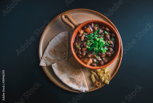 Принти на полотні A high angle view/color studio image of Egyptian, Arabian, Middle Eastern Traditional food (Fava Beans with Vegetables/Green Paprika) A