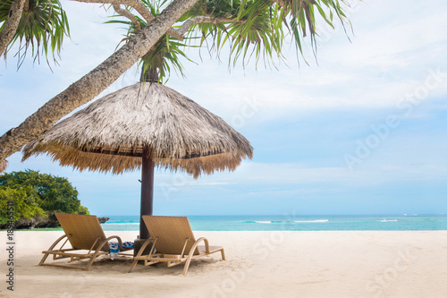 Sun loungers white tropical beach blue ocean shore