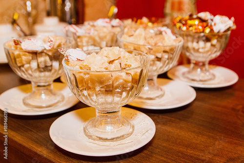 Brown sugar and candy bowls closeup on the table, warm tone © dxoroshun