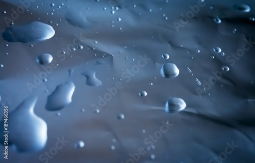 Texture of crumpled foil with water drops. Rectangular horizontal background.