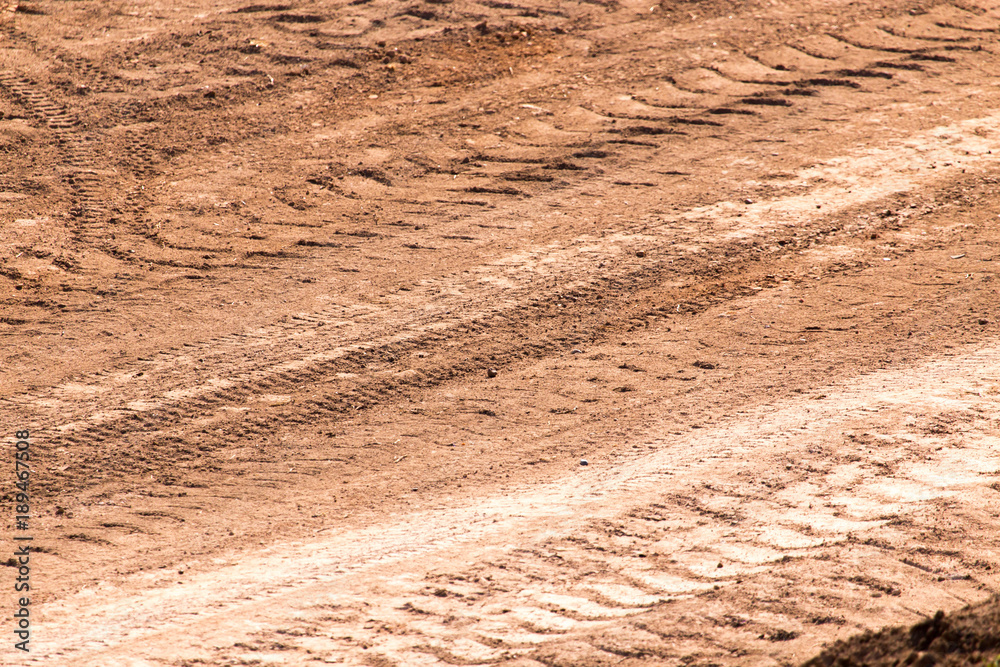 Naklejka premium Traces from the car on the red clay soil
