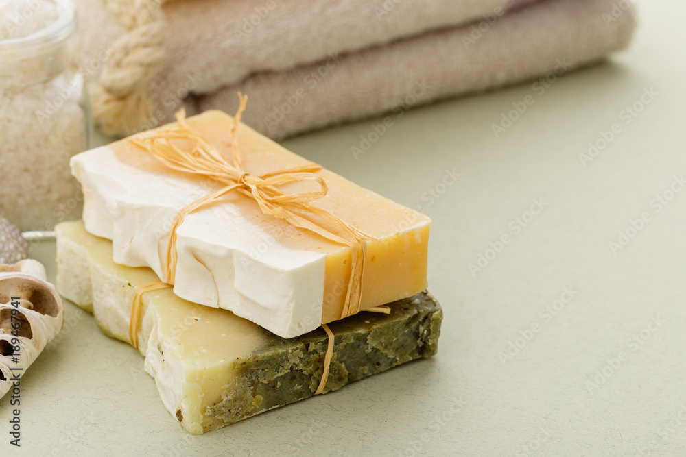 Natural organic soap with toiletries on olive green background Natural organic soap with toiletries on olive green background