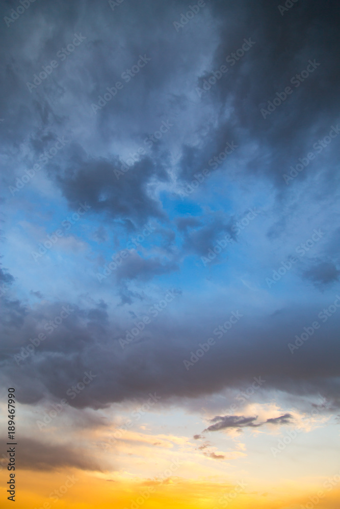 Storm clouds in the sky at sunset as background