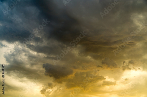 Storm clouds in the sky at sunset as background