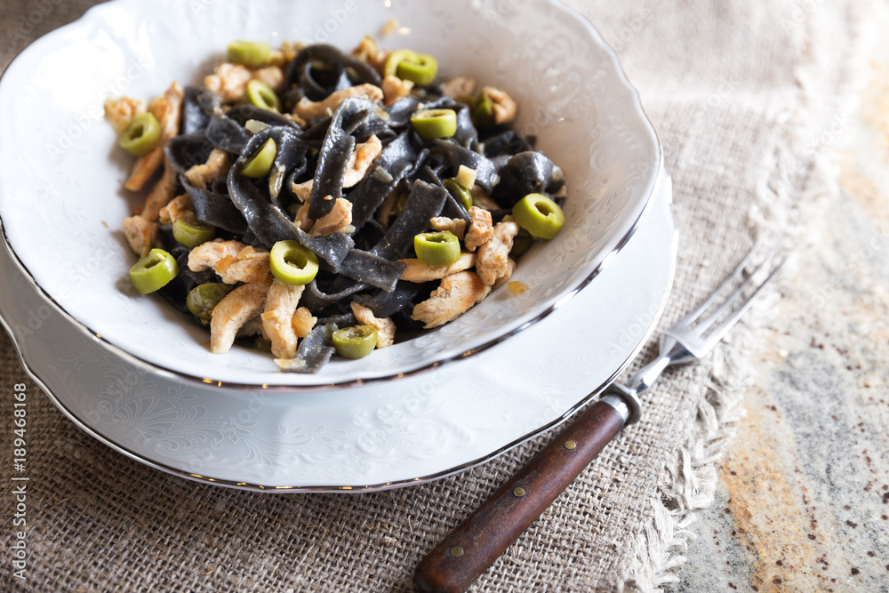 Black ink pasta with chicken and green olives