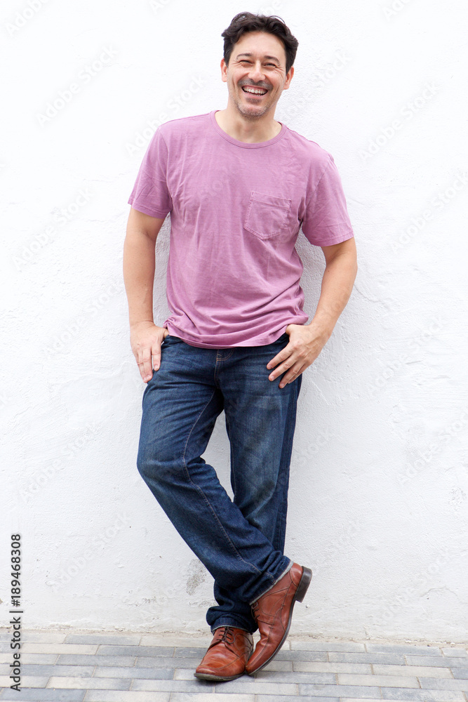 handsome middle aged man smiling against white wall handsome middle aged man smiling against white wall
