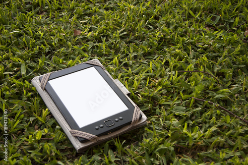 An electronic book reader on the grass