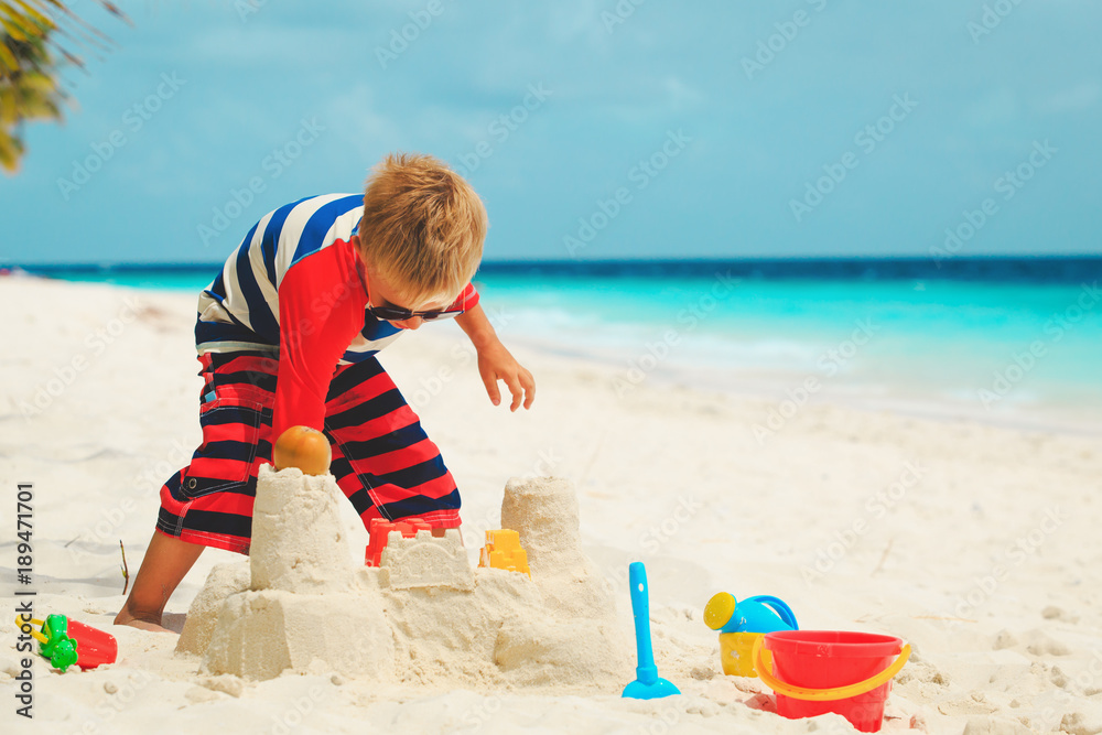 little boy play with sand on beach little boy play with sand on beach