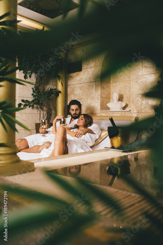 Beautiful young couple enjoying and relaxing in SPA center