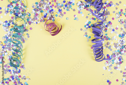 Background of yellow color, decorated celebration with confetti and balloons. Copyspace
