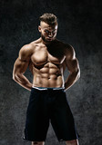 Sporty muscular man shirtless. Photo of man with perfect body after training. Strength and motivation