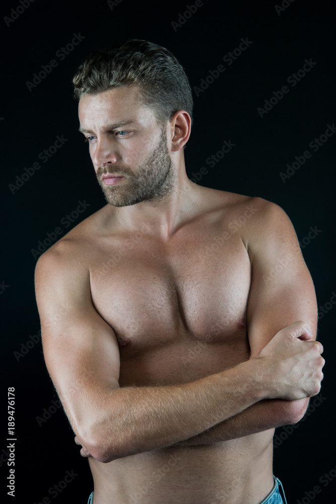 Fototapeta premium Man with sexy torso, muscles, biceps, triceps on dark background