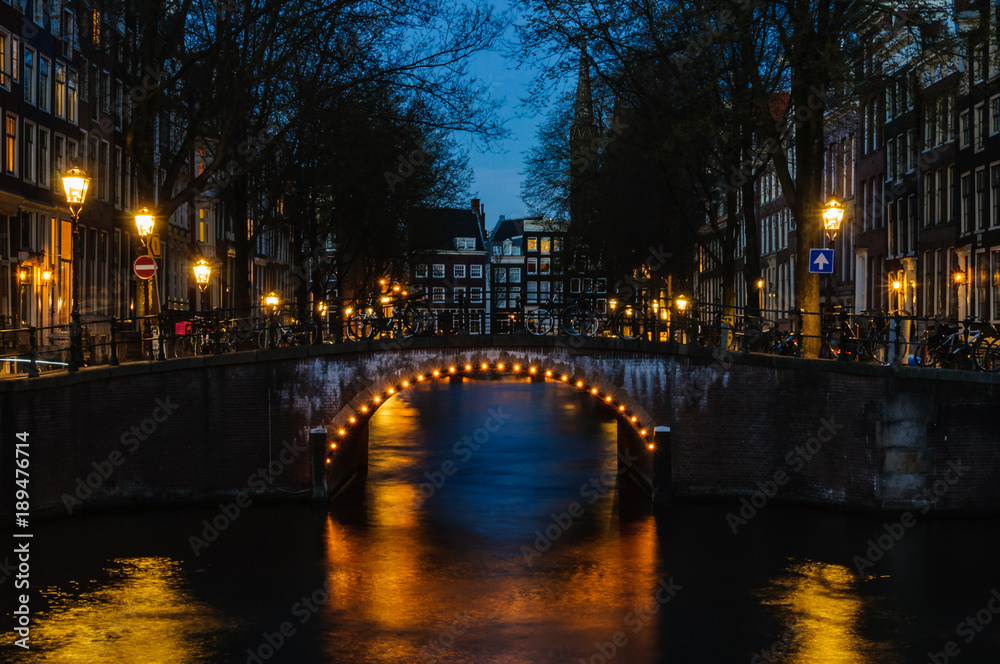 Bridges at night in Canals of Amsterdam, Holland