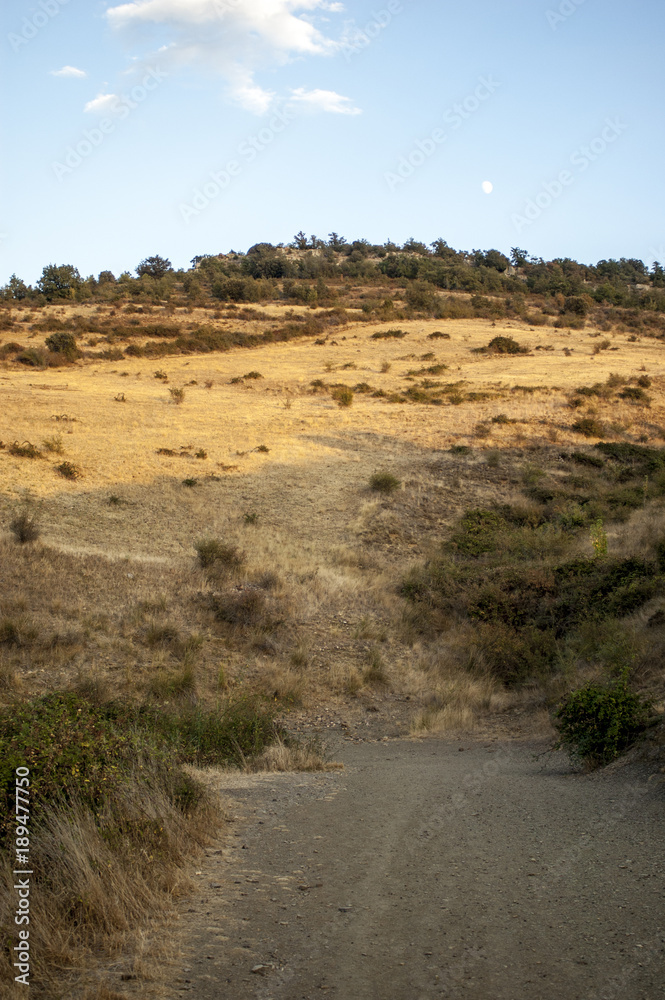 Rural road next to the slope of the mountain Rural road next to the slope of the mountain