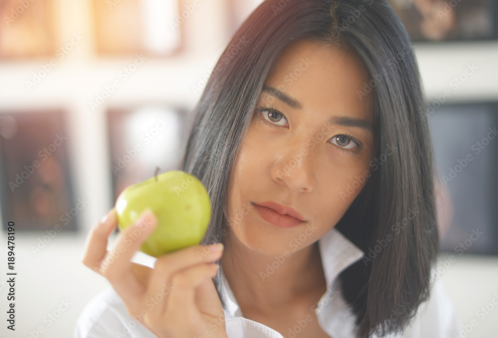 Portrait of happy young woman Asian holding apple
Portrait of happy young woman Asian holding apple