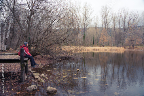 Female mountain climber sitting on mountain pier enjoying the peace of the place