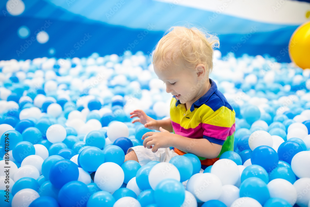 Kids play in ball pit. Child playing in balls pool Kids play in ball pit. Child playing in balls pool