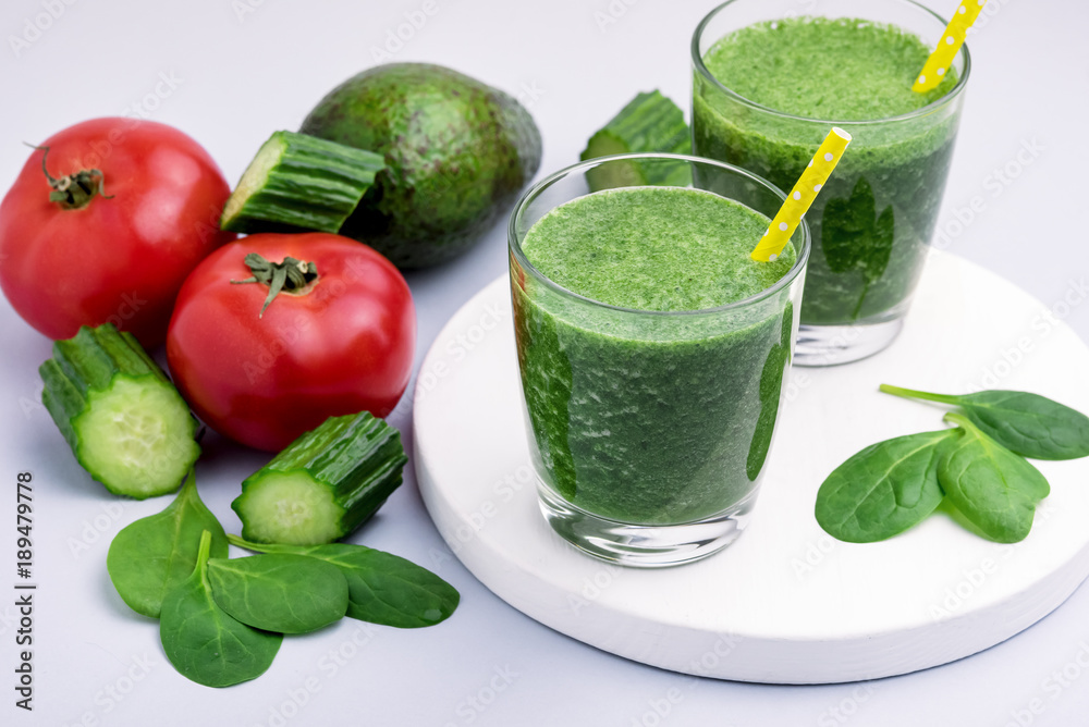 Fresh Tasty Spinach Cucumber Avocado Tomato Smoothie in Glasses Fresh Vgetables Detox Drink White Wooden Tray Gray Background Horizontal Fresh Tasty Spinach Cucumber Avocado Tomato Smoothie in Glasses Fresh Vgetables Detox Drink White Wooden Tray Gray Background Horizontal