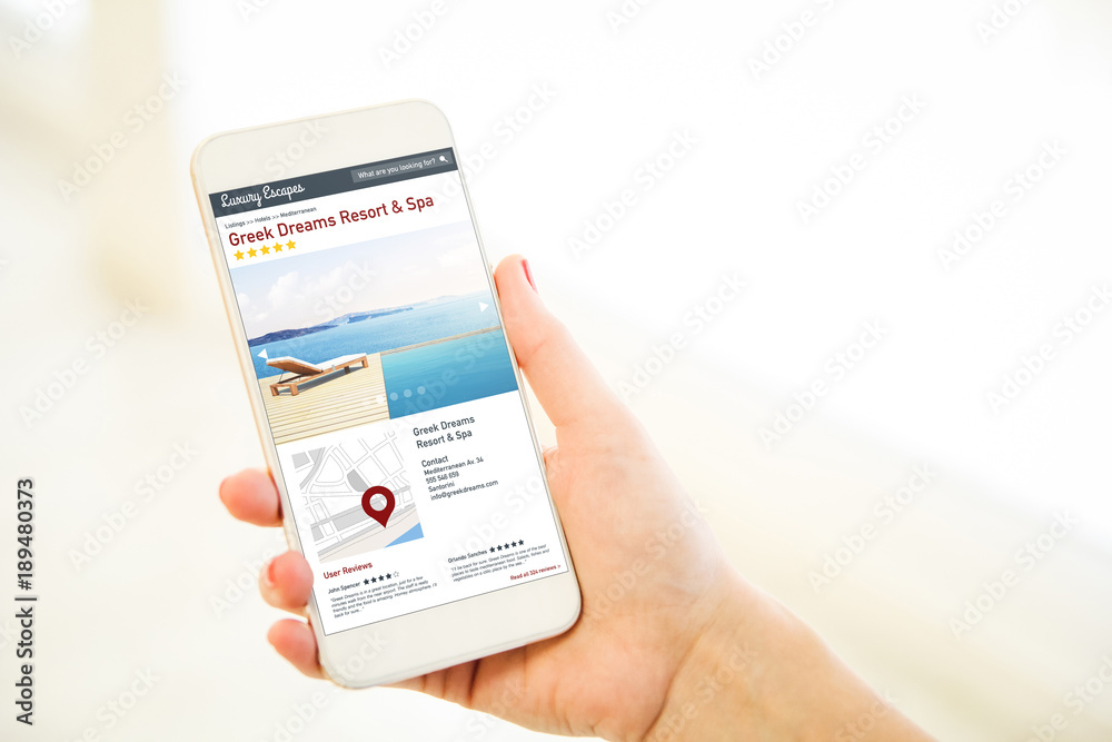 Woman holding a pink gold blank smartphone luxury escapes directory Woman holding a pink gold blank smartphone luxury escapes directory