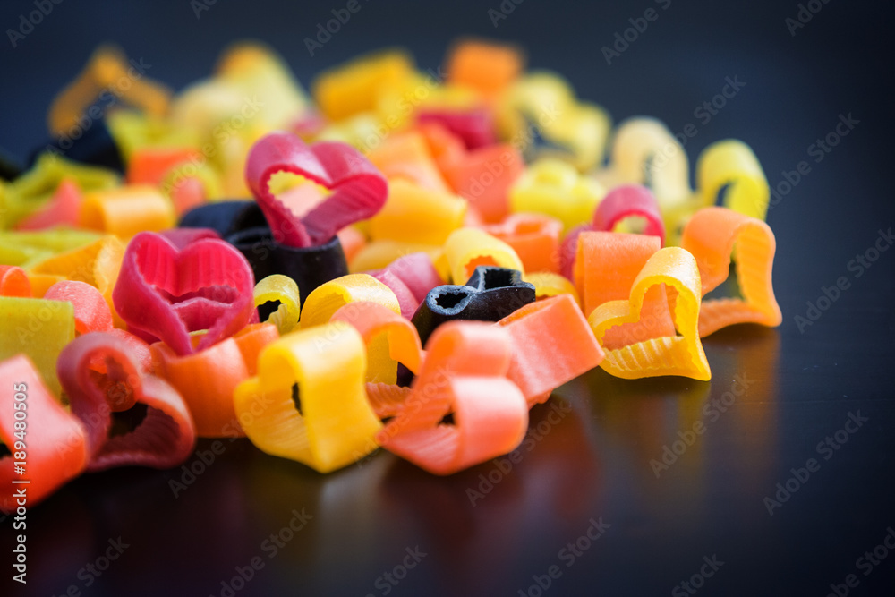Heart-shaped pasta on black table. Heart-shaped pasta on black table.